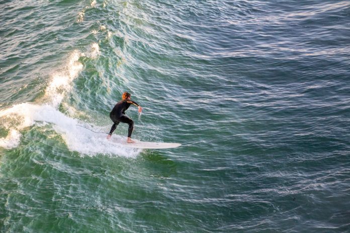 A girl learns surfing - beginner surf spots in san Diego